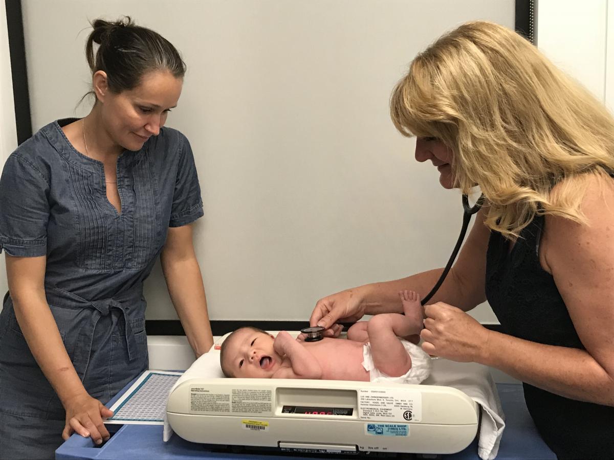 Dr. Ashley Smith (L) looks on as Dr. McLachlan checks out Baby Sakurako.