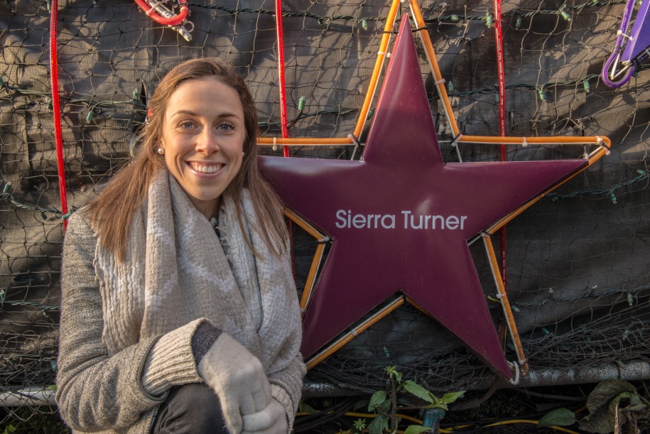 Photo of Sierra Turner in front of Light of Hope star at St. Paul's Hospital