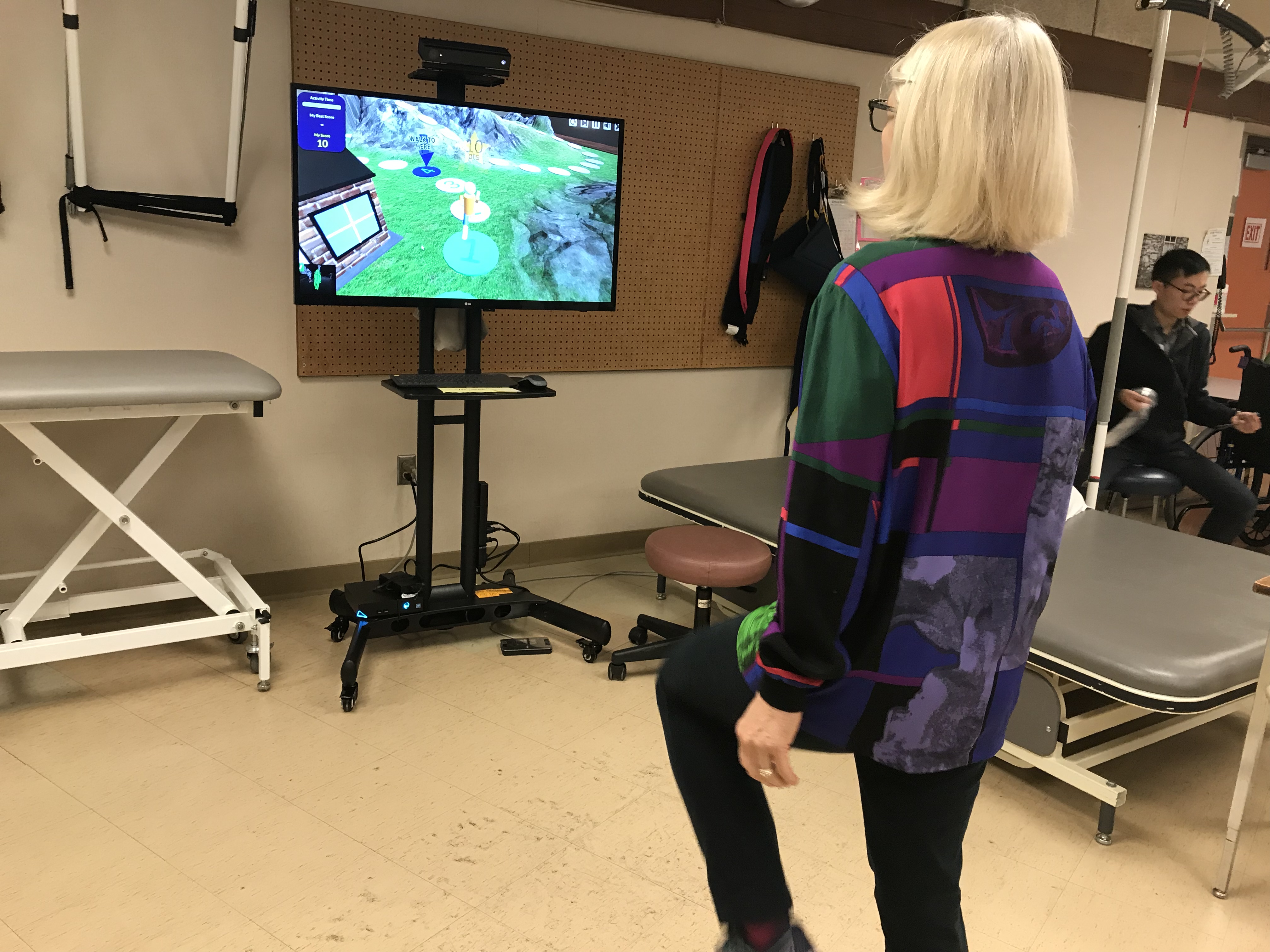 Occupational Therapist Lori Sinclair shows off the new virtual reality system.