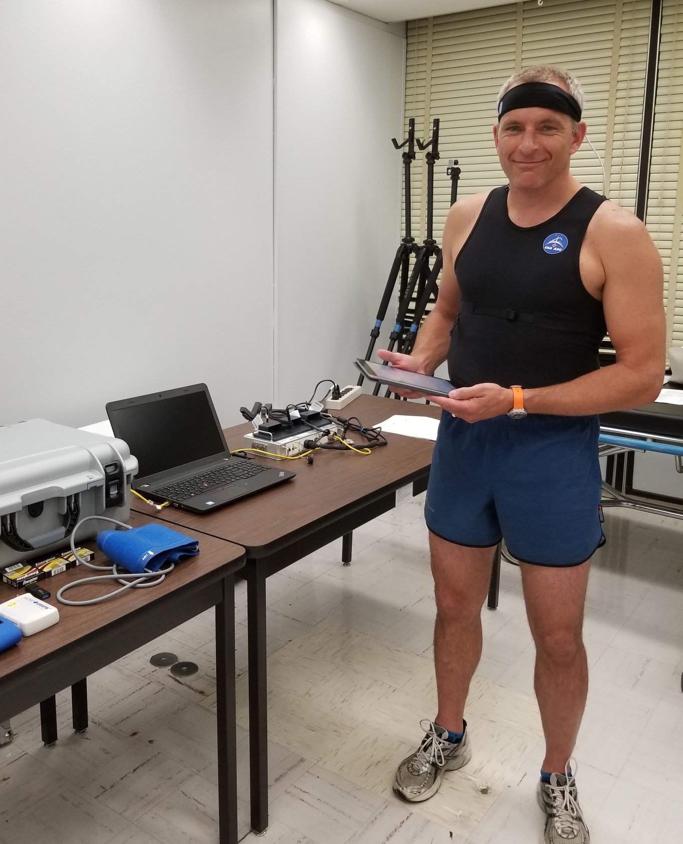 David Saint-Jacques wears special Bio Monitor shirt, standing in lab.