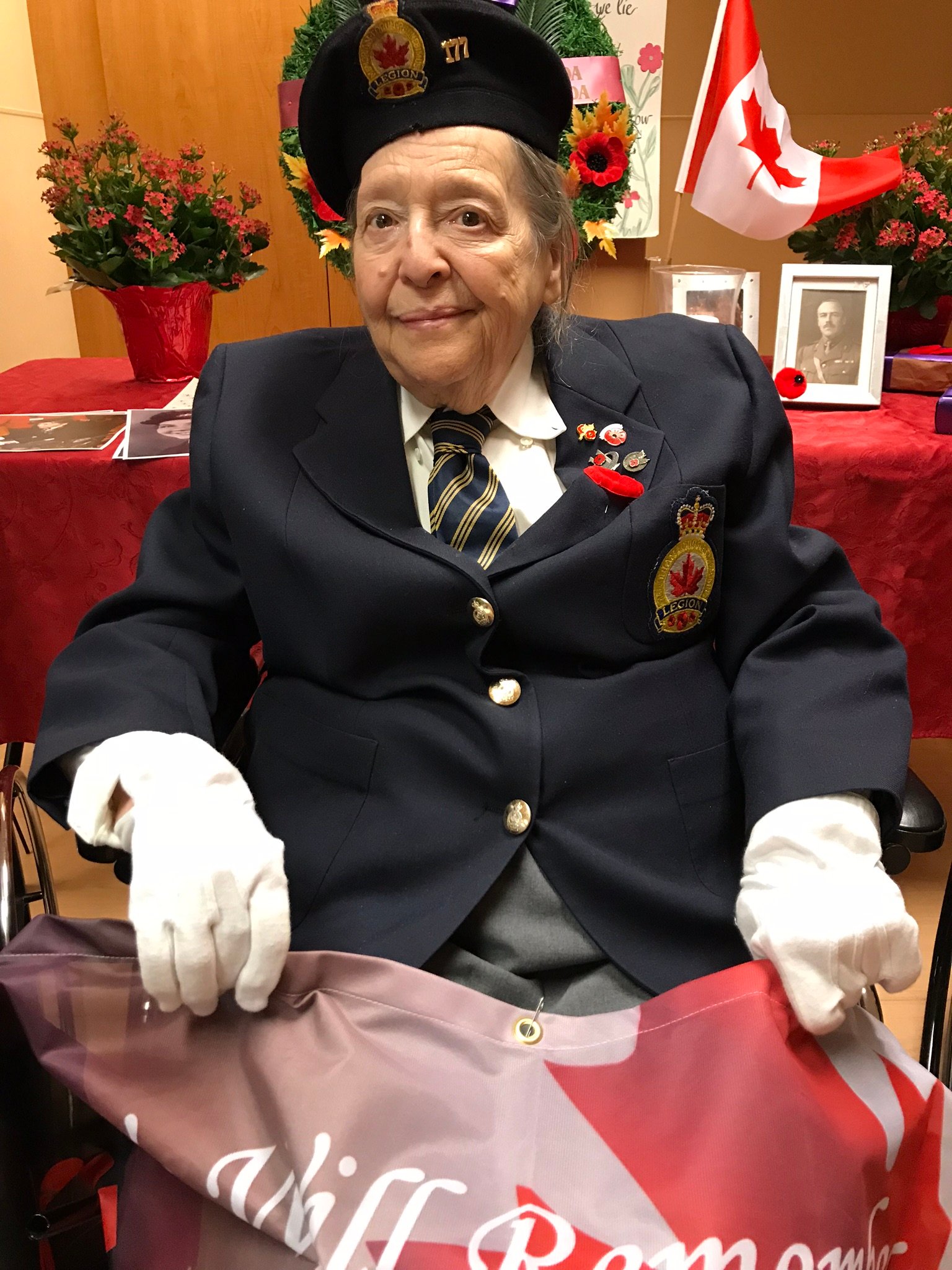 Royal Canadian Air Force veteran Colleen de Serres sitting with flag in her lap.