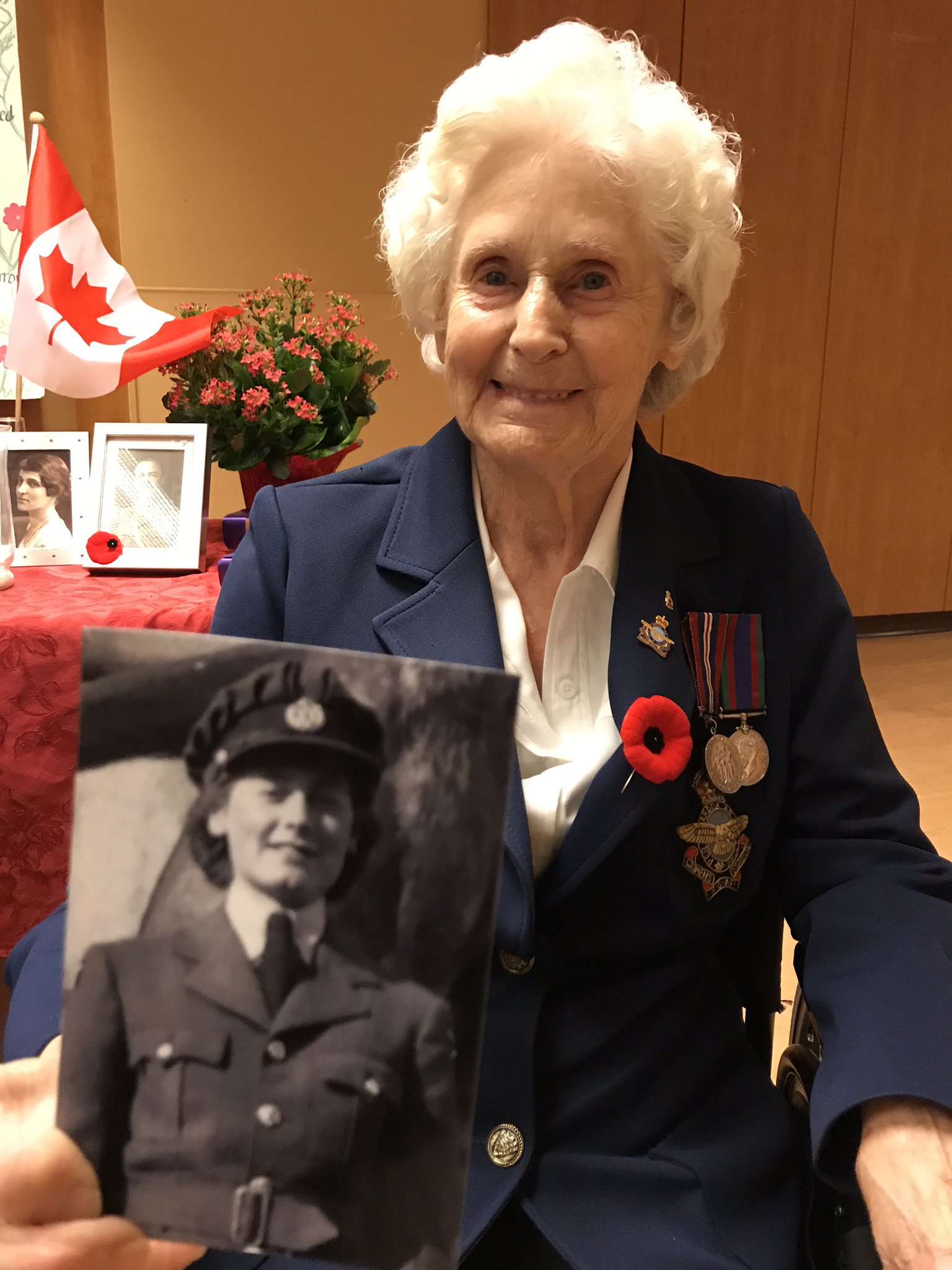 Royal Canadian Air Force veteran Geraldine Grimway holds a photo of herself from her service days.