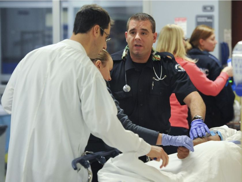 BC Ambulance paramedics confer with Emergency Department doctor Frank Scheuermeyer (left) about an intoxicated man brought to the hospital moments earlier. Courtesy Jason Payne, Province