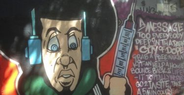 Graffiti on Vancouver’s Downtown Eastside urges intravenous drug users to use the Insite supervised injection facility and to carry Narcan to reverse overdoses.