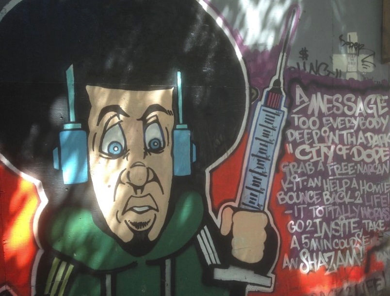 Graffiti on Vancouver’s Downtown Eastside urges intravenous drug users to use the Insite supervised injection facility and to carry Narcan to reverse overdoses.