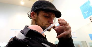 Twice a day Kieran Collins, 39, injects prescription-grade heroin at the Crosstown Clinic in Vancouver. (Nick Purdon/CBC)