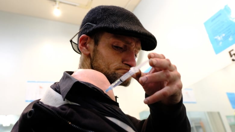 Twice a day Kieran Collins, 39, injects prescription-grade heroin at the Crosstown Clinic in Vancouver. (Nick Purdon/CBC)