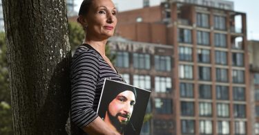 Sia Kaskamanidis with a photo of her late brother Saki Kaskas, whose original album Theodosius will be posthumously released on June 28 at the ANZA Club. (Photo courtesy of Dan Toulgoet/ Vancouver Courier)