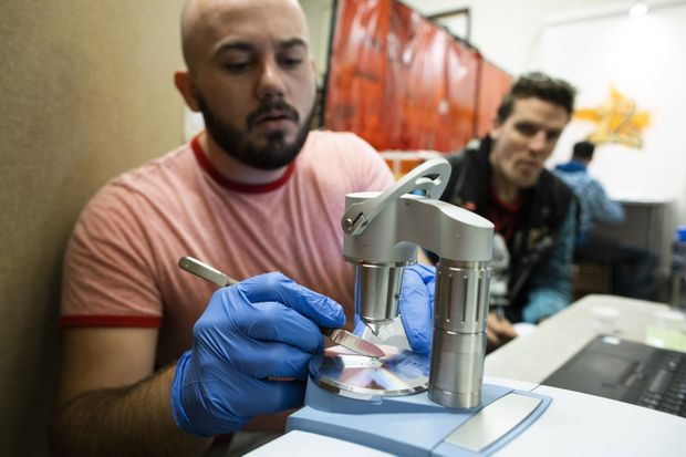 Kyle Besaw, left, drug checking tech aid with Vancouver Coastal Health, and Trey Helten, right, supervisor at the Overdose Prevention Society safe injection site, check samples of heroin for fentanyl and other substances in Vancouver, British Columbia, July 11, 2019. (Photo Credit: RAFAL GERSZAK/THE GLOBE AND MAIL)