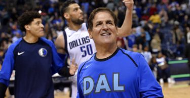 Dallas Mavericks owner Mark Cuban walks off of the court ahead of forward Justin Jackson, left, and center Salah Mejri (50) after an NBA basketball game. (Photo courtesy of Brandon Dill)