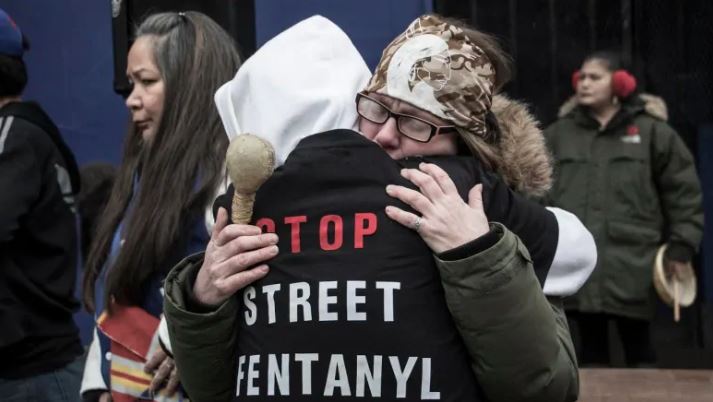 Two people embrace at a vigil held in Vancouver on the province's overdose crisis. (Photo Credit: Tina Lovgreen/CBC)