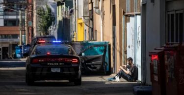 A man has an interaction with police officers in Vancouver's Downtown Eastside on Friday, Sept. 6. (Photo Credit: Ben Nelms/CBC)