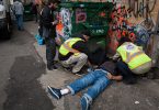 Staff members from the popup safe injection tent prepare the insect a man with Naloxone as he overdoses in a Downtown Eastside alley in Vancouver, British Columbia, November 18, 2016. (Photo Credit: Rafal Gerszak)