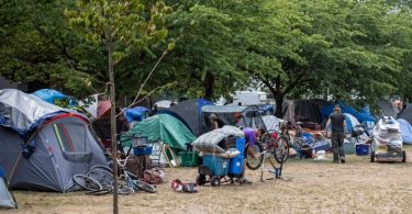 Vancouver fire and park board officials take away mattresses while checking on vacant tents at Oppenheimer Park in Vancouver, British Columbia on Tuesday, Aug. 20, 2019. (Photo Credit: Ben Nelms/CBC)