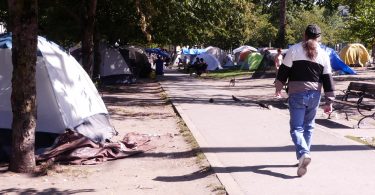 A man walks through the homeless camp at Oppenheimer Park in Vancouver on Sept. 6, 2019. (Photo Credit: Lasia Kretzel, NEWS 1130)