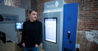 MySafe founder and infectious disease doctor Mark Tyndall stands next to the country's first machine that dispenses prescribed hydromorphone to high-risk opioid addicts in Vancouver's Downtown Eastside. (Ben Nelms/CBC)