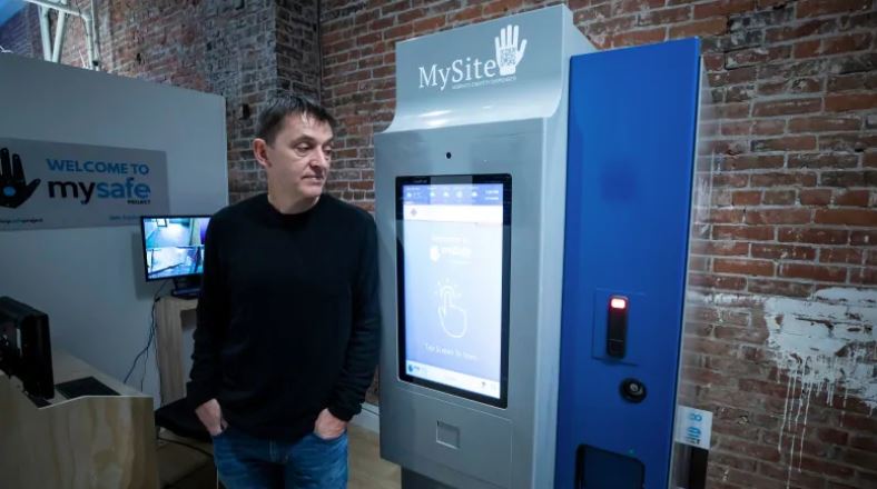MySafe founder and infectious disease doctor Mark Tyndall stands next to the country's first machine that dispenses prescribed hydromorphone to high-risk opioid addicts in Vancouver's Downtown Eastside. (Ben Nelms/CBC)