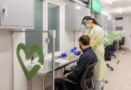 Passenger receiving rapid antigen test at YVR airport