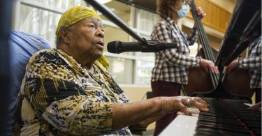 Eve Duke, backed-up by standup bassist Wendy Solloway and drummer Paul Adams, not pictured, plays the grand piano at St. Vincent's Langara care home in Vancouver on June 10. (Photo credit: Vancouver Sun)