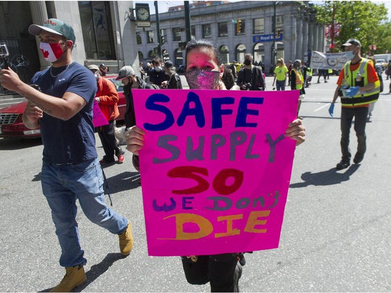 Several dozen protestors march through the Downtown Eastside of Vancouver, BC Tuesday, May 11, 2021 calling for a safe supply of street drugs. (Photo credit: The Province)