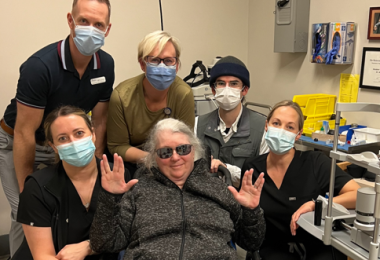 Patient Jody Burns poses with the care team that helped her restore her vision, including Dr. Heather O'Donnell and allied health professionals.