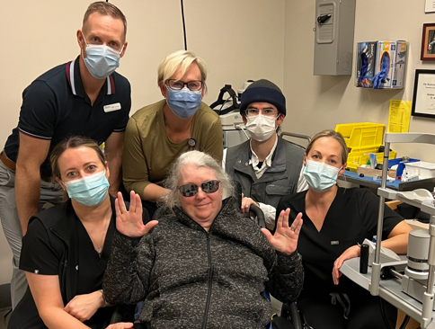 Patient Jody Burns poses with the care team that helped her restore her vision, including Dr. Heather O'Donnell and allied health professionals.