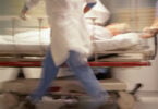 Doctors pushing patient on trolley