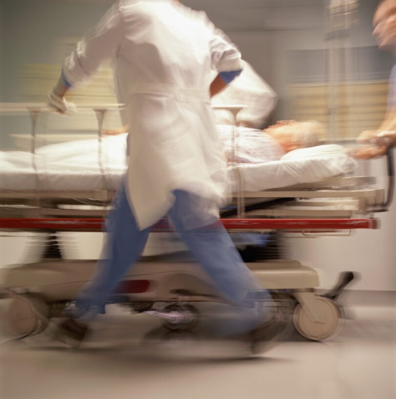 Doctors pushing patient on trolley